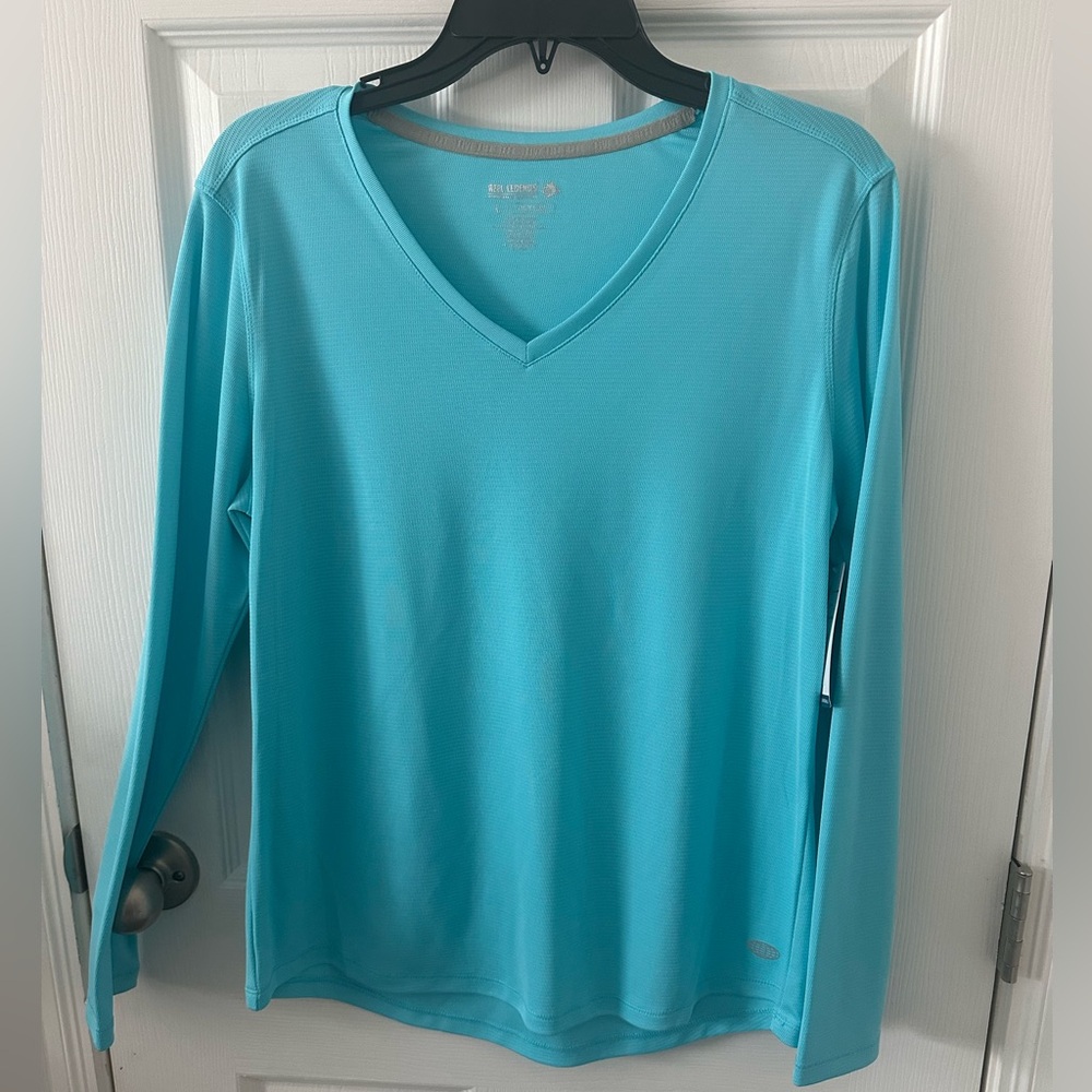 Reel legends women’s v-neck performance top. NWT, size large. Pretty blue!